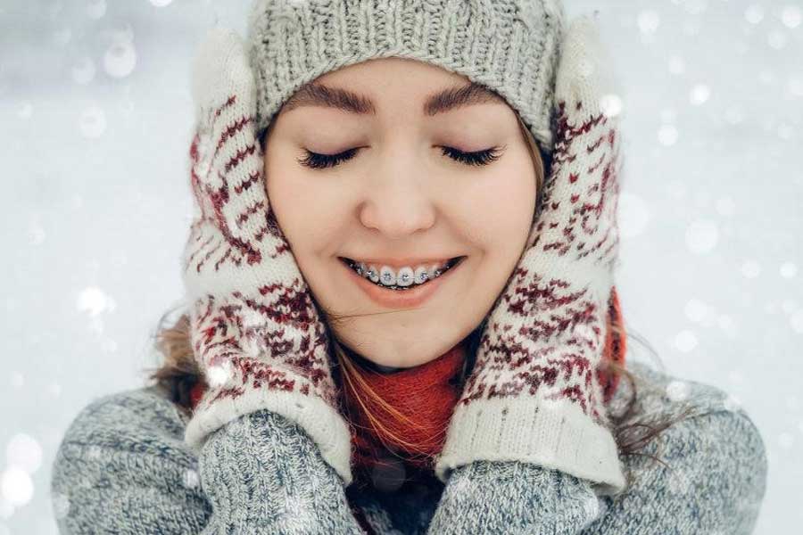 Woman with braces wearing winter clothing